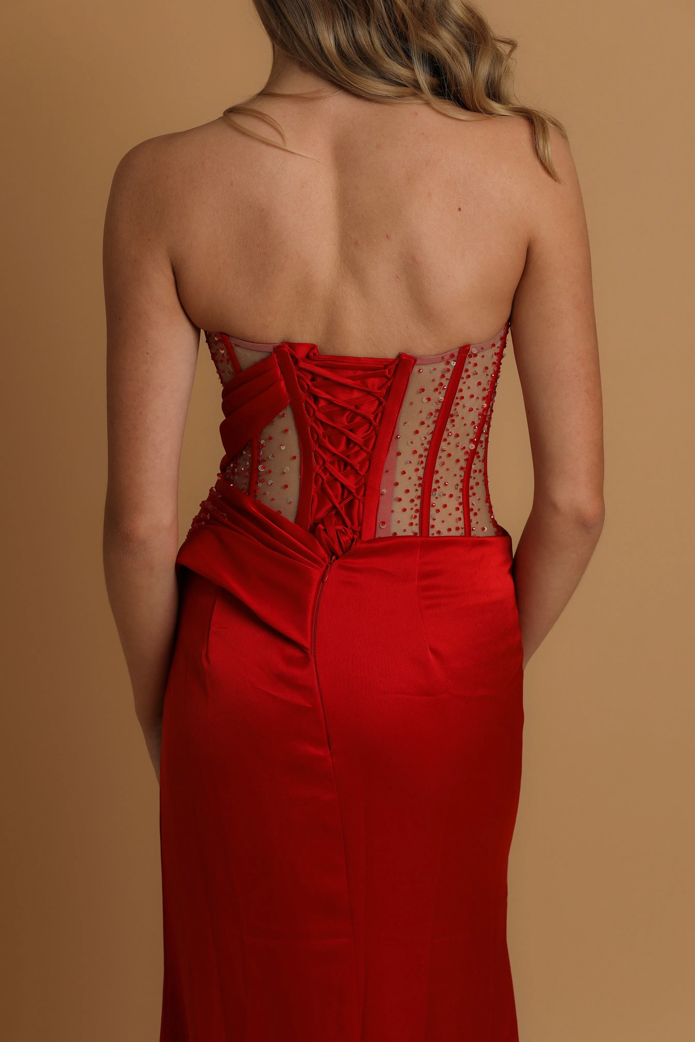 red high slit dress with corset back fore hire